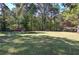 Large grassy backyard bordered by trees at 810 Mcconnell Rd, Powder Springs, GA 30127