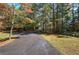 Asphalt driveway surrounded by lush greenery at 810 Mcconnell Rd, Powder Springs, GA 30127