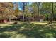 Brick house with a large backyard and fall foliage at 810 Mcconnell Rd, Powder Springs, GA 30127