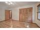 Hardwood floor bedroom with built-in closet and window at 810 Mcconnell Rd, Powder Springs, GA 30127