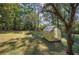 Backyard with greenhouse and large shade tree at 810 Mcconnell Rd, Powder Springs, GA 30127