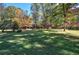 Large backyard with mature trees and a brick house at 810 Mcconnell Rd, Powder Springs, GA 30127