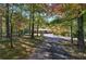 Brick ranch house nestled in a wooded lot with a long driveway at 810 Mcconnell Rd, Powder Springs, GA 30127