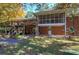 Brick house with screened porch and deck, surrounded by trees at 810 Mcconnell Rd, Powder Springs, GA 30127