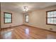 Spacious bedroom with hardwood floors and multiple windows at 810 Mcconnell Rd, Powder Springs, GA 30127