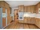 Bright kitchen with wood cabinets, white appliances, and hardwood floors at 810 Mcconnell Rd, Powder Springs, GA 30127