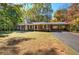 Brick ranch house with attached carport, situated on a spacious lot with mature trees at 810 Mcconnell Rd, Powder Springs, GA 30127
