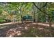 Metal storage shed nestled in a wooded area of the property at 810 Mcconnell Rd, Powder Springs, GA 30127
