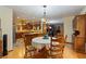 Kitchen and dining area with wood cabinets and island at 8865 Watkins Rd, Chattahoochee Hills, GA 30268