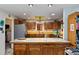 Kitchen with wood cabinets, tile countertops and island at 8865 Watkins Rd, Chattahoochee Hills, GA 30268