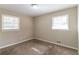 Cozy carpeted bedroom with two windows and neutral walls at 929 Pine Roc Dr, Stone Mountain, GA 30083