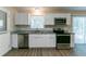 Modern kitchen with stainless steel appliances and white cabinets at 929 Pine Roc Dr, Stone Mountain, GA 30083