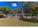 Brick ranch house with a red door and attached garage at 929 Pine Roc Dr, Stone Mountain, GA 30083
