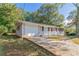 Brick ranch house with attached garage and landscaping at 929 Pine Roc Dr, Stone Mountain, GA 30083