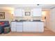 Basement wet bar with white cabinets, granite countertop, and mini-fridge at 801 Hampton Sw Pl, Marietta, GA 30064