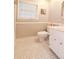 Small bathroom with toilet, vanity, and tile floor. Neutral colors and trim at 801 Hampton Sw Pl, Marietta, GA 30064