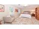 Bedroom with queen bed, armchair, and patterned rug. Built-in shelves and window at 801 Hampton Sw Pl, Marietta, GA 30064