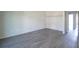 Bright bedroom featuring gray vinyl flooring and closet at 3158 Olive Tree Ct, Decatur, GA 30034
