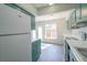 Modern kitchen with teal cabinets and white appliances at 3158 Olive Tree Ct, Decatur, GA 30034