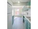 Bright kitchen with teal cabinets, white appliances, and white countertops at 3158 Olive Tree Ct, Decatur, GA 30034