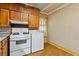Kitchen with wood cabinets, stove, and view into another room at 2243 Tiger Flowers Nw Dr, Atlanta, GA 30314