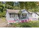 Cute bungalow, gray siding, pink base, and a porch at 2243 Tiger Flowers Nw Dr, Atlanta, GA 30314