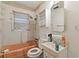 Bathroom with pink tub, toilet, sink, and medicine cabinet at 2243 Tiger Flowers Nw Dr, Atlanta, GA 30314