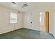 Small bedroom with window, carpet, and access to another room at 2243 Tiger Flowers Nw Dr, Atlanta, GA 30314