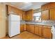 Kitchen with wood cabinets, refrigerator, and sink at 2243 Tiger Flowers Nw Dr, Atlanta, GA 30314