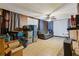 Unfinished basement with a couch, boxes, and ceiling fan at 2243 Tiger Flowers Nw Dr, Atlanta, GA 30314