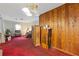 Living area with wood paneling and red carpet at 2243 Tiger Flowers Nw Dr, Atlanta, GA 30314