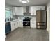 Modern kitchen with white cabinets and stainless steel appliances at 6848 Maddox Rd, Morrow, GA 30260