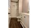 Clean bathroom with white vanity, shower, and dark brown tile floor at 198 Lucan Way, Riverdale, GA 30274