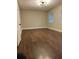 Large living room with dark brown wood-look flooring at 198 Lucan Way, Riverdale, GA 30274