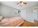 Bedroom with wood floors, ceiling fan, and ample closet space at 5239 Phillips Dr, Morrow, GA 30260