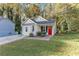 Quaint house with a red door, well-maintained lawn, and mature trees at 2003 Glenwood Downs Dr, Decatur, GA 30035