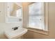 Small bathroom with pedestal sink and medicine cabinet at 56 Clay Se St, Atlanta, GA 30317