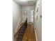 Upstairs hallway with hardwood floors and open staircase at 35 Intown Pl, Fayetteville, GA 30214