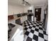 Modern kitchen with white cabinets, checkerboard floor, and stainless steel appliances at 35 Intown Pl, Fayetteville, GA 30214