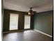 Large bedroom with dark gray floors and ceiling fan at 1101 Lenox Ne Way # 1101, Atlanta, GA 30324