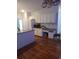 White kitchen cabinets, granite counters, and hardwood floors at 533 Riverbirch Trce, Stone Mountain, GA 30087