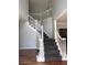 Grand staircase with grey carpeting and white railing at 533 Riverbirch Trce, Stone Mountain, GA 30087