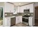 Updated kitchen, featuring white shaker cabinets, stainless steel appliances, and geometric backsplash at 2184 Asquith Sw Ave, Marietta, GA 30008