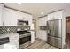 Modern kitchen with white cabinets, stainless steel appliances, and quartz countertops at 2184 Asquith Sw Ave, Marietta, GA 30008