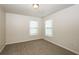 Well-lit bedroom with two windows and neutral decor at 4815 Plainsman Cir, Cumming, GA 30028