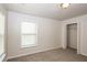 Bright bedroom featuring carpet, a double-door closet, and window blinds at 4815 Plainsman Cir, Cumming, GA 30028