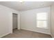 Simple bedroom with carpeted floor, a closet, and a window with blinds at 4815 Plainsman Cir, Cumming, GA 30028