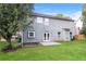 Two story home with gray siding, a patio, and a grassy backyard at 4815 Plainsman Cir, Cumming, GA 30028