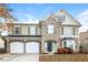 Two-story house with stone and shingle exterior, two-car garage at 4815 Plainsman Cir, Cumming, GA 30028