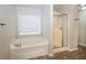 Relaxing bathroom with soaking tub and walk-in shower at 4815 Plainsman Cir, Cumming, GA 30028